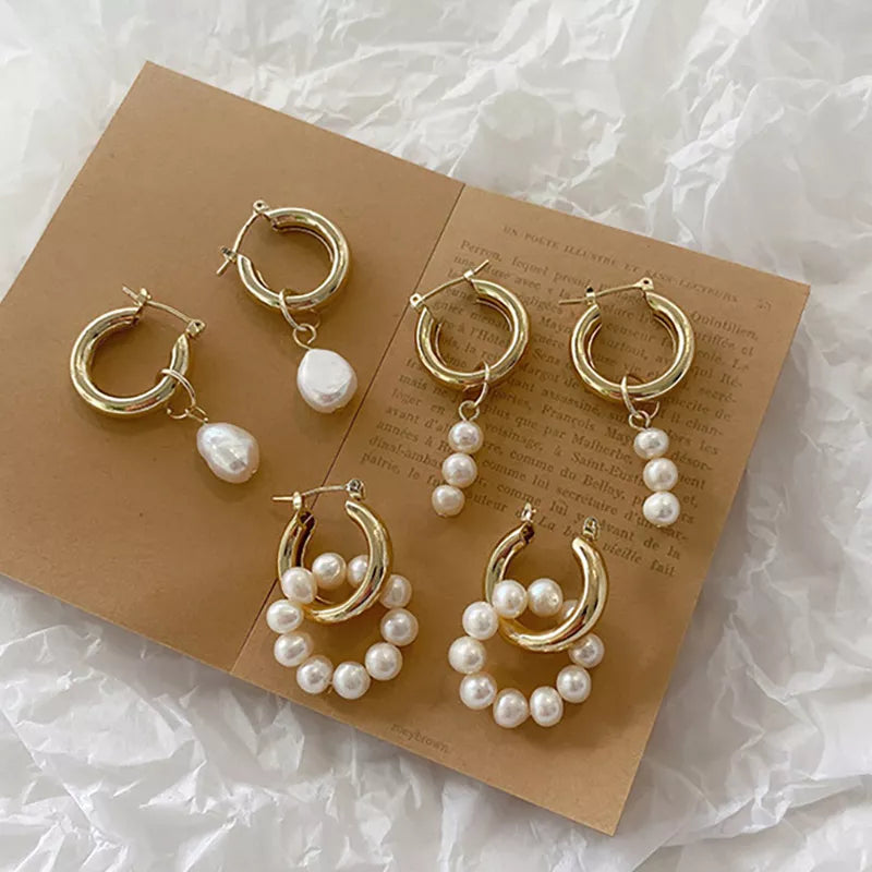 Experience contemporary luxury with Ariana Modern Luxe Huggies. Sleek earrings that hug your earlobe, featuring a row of pearls for a sophisticated look. Elevate your style with these modern and opulent accessories.