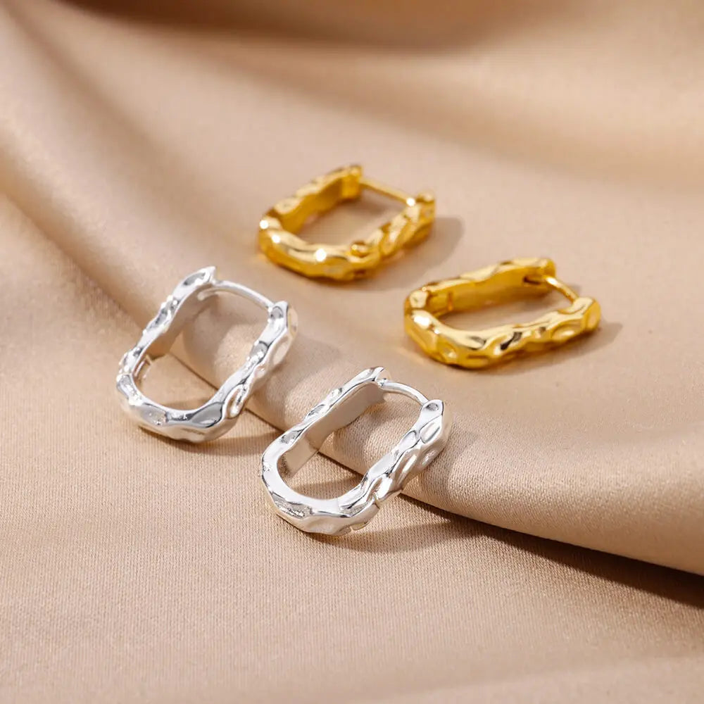 A pair of Taylor U-Shaped Earrings in gold, beautifully designed to add a touch of modern sophistication to your jewellery collection."