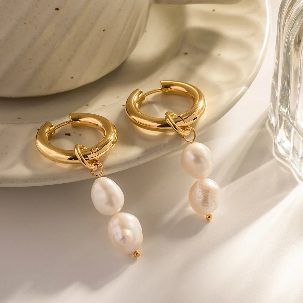 The earrings gracefully dangle, adding a splash of class to any ensemble. The dual pearls catch the light, enhancing their beauty and contributing to the overall elegance.