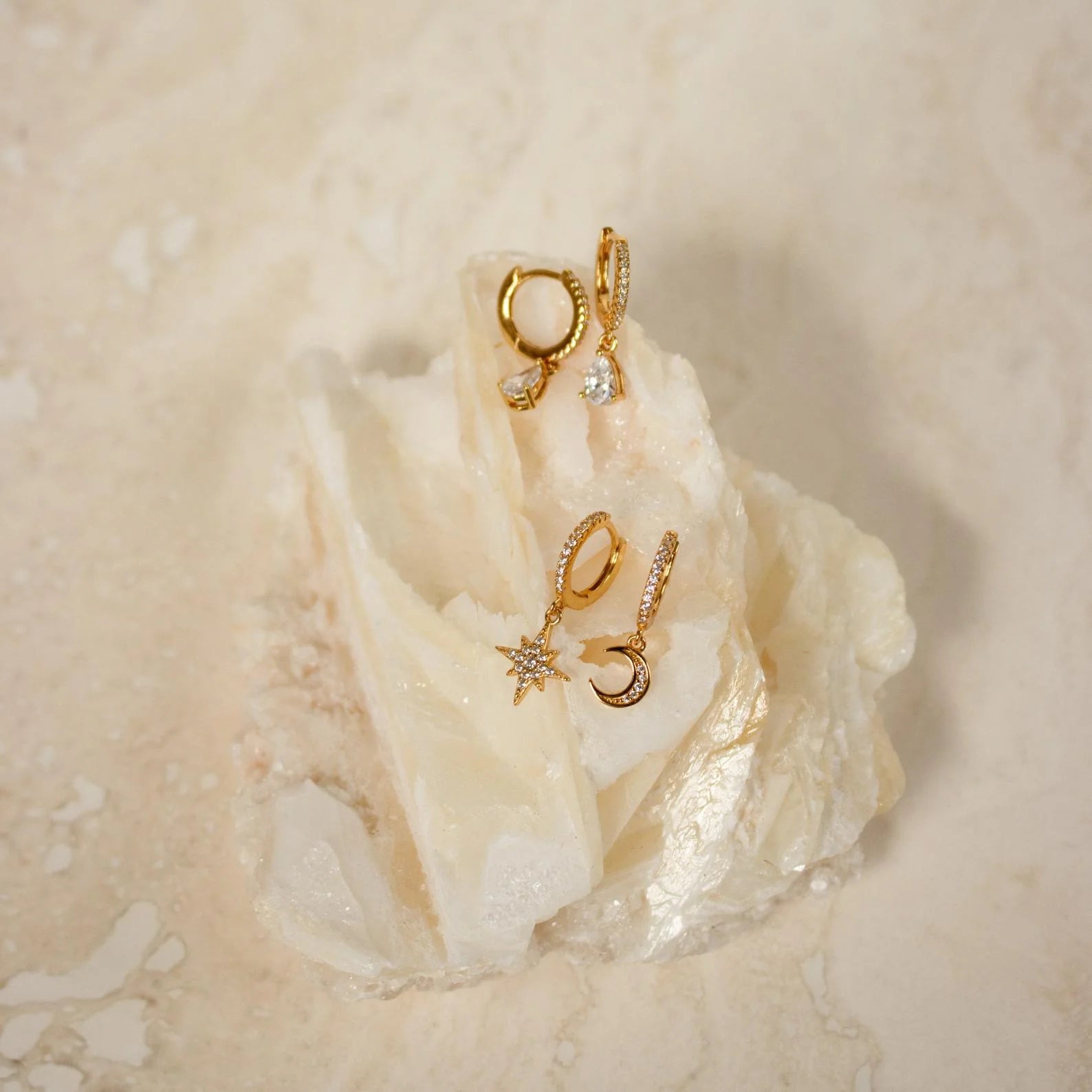 Gypsea Jewelry Collection Display: Showcase the earrings as part of Gypsea's broader jewelry collection, conveying a sense of cohesion and inviting customers to explore more celestial-inspired pieces.